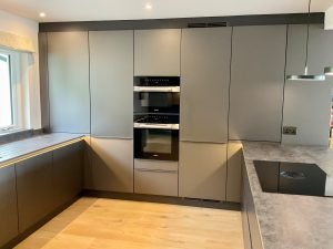 Modern dark kitchen - bank of tall units